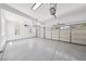 Spacious three car garage with epoxy flooring and white walls at 2297 Aria Dr, Henderson, NV 89052