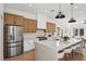 Gourmet kitchen with stainless steel appliances, a large center island, and contemporary lighting at 2297 Aria Dr, Henderson, NV 89052