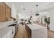 The bright, open kitchen features stainless steel appliances, a large island, and views into the backyard at 2297 Aria Dr, Henderson, NV 89052