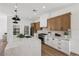 Open kitchen with a large island, stainless steel appliances, and custom cabinetry for a luxurious feel at 2297 Aria Dr, Henderson, NV 89052