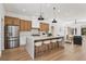 Spacious open concept kitchen with seating at the island, stainless appliances, and plenty of natural light at 2297 Aria Dr, Henderson, NV 89052