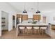 Modern kitchen with stainless steel appliances, island with seating, and bright lighting at 2297 Aria Dr, Henderson, NV 89052
