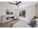 Modern main bedroom with fireplace, TV, and window view offers a serene retreat at 2297 Aria Dr, Henderson, NV 89052