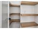 Spacious pantry features natural wood shelving for ample and organized storage space at 2297 Aria Dr, Henderson, NV 89052