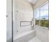 Modern shower features stylish tile, black fixtures and bench seating with a window view at 2297 Aria Dr, Henderson, NV 89052