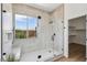 Contemporary shower boasts glass enclosure, built-in niche, and ample natural light at 2297 Aria Dr, Henderson, NV 89052