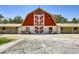 Exterior of a red and white barn featuring Sierra Vista Ranchos signage, with a traditional rural aesthetic at 2770 La Casita Ave, Las Vegas, NV 89120
