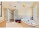Bright bathroom with separate glass-blocked shower and a large soaking tub at 2770 La Casita Ave, Las Vegas, NV 89120