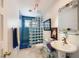 Modern bath with a mosaic tile shower, glass block partition, floating glass shelves, and neutral finishes at 2770 La Casita Ave, Las Vegas, NV 89120