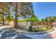 Community entrance with brick and white fence, landscaping, and decorative lamps at 2770 La Casita Ave, Las Vegas, NV 89120