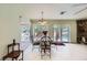 Bright dining area with views of the pool through sliding glass doors and a stone accent wall at 2770 La Casita Ave, Las Vegas, NV 89120