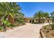 View of a single-story ranch home showcasing mature trees, rock accents, and a concrete driveway at 2770 La Casita Ave, Las Vegas, NV 89120