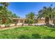 Charming single-story home with lush lawn, mature palm trees, and a well-maintained stone facade at 2770 La Casita Ave, Las Vegas, NV 89120