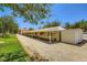 Exterior shot of the ranch's horse stalls, showing covered area and adjacent grassy areas at 2770 La Casita Ave, Las Vegas, NV 89120