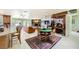 Open-concept living room featuring a fireplace, an adjacent dining area, and tons of natural light at 2770 La Casita Ave, Las Vegas, NV 89120