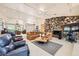 Open living room features tile floors, a stone fireplace, and a large ceiling fan at 2770 La Casita Ave, Las Vegas, NV 89120