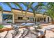 This covered patio features beautiful tile work and stylish wrought iron patio furniture surrounded by lush greenery and palms at 2770 La Casita Ave, Las Vegas, NV 89120