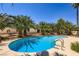 Large swimming pool with a sun deck and surrounded by palm trees in backyard at 2770 La Casita Ave, Las Vegas, NV 89120