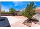 Backyard area with brick patio, mature trees, and block fence at 309 Clifton Heights Dr, Las Vegas, NV 89145