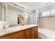 Bathroom featuring a double sink vanity with granite countertop and a shower-tub combo at 309 Clifton Heights Dr, Las Vegas, NV 89145