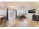 Open-concept dining area with a view of the kitchen, tile flooring, and sliding glass doors to the outdoor area at 309 Clifton Heights Dr, Las Vegas, NV 89145