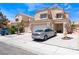 View of the home exterior highlighting the driveway, two-car garage and desert landscaping at 309 Clifton Heights Dr, Las Vegas, NV 89145