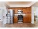 Well-appointed kitchen with stainless steel appliances, wood cabinets, and tile flooring at 309 Clifton Heights Dr, Las Vegas, NV 89145