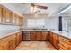Bright kitchen featuring wood cabinets, tile floors, granite countertops, and stainless steel appliances at 309 Clifton Heights Dr, Las Vegas, NV 89145