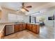 Bright kitchen featuring wood cabinets, tile floors, granite countertops, and stainless steel appliances at 309 Clifton Heights Dr, Las Vegas, NV 89145