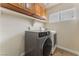 Laundry room featuring a modern washer and dryer, and shelving for storage at 309 Clifton Heights Dr, Las Vegas, NV 89145