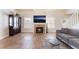 Cozy living room with a fireplace, built-in shelving, and a large picture window at 309 Clifton Heights Dr, Las Vegas, NV 89145