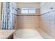 Bathtub-shower area with tiled walls, a shower head, a small window and a shower curtain at 309 Clifton Heights Dr, Las Vegas, NV 89145