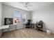 Bright bedroom showcasing a ceiling fan, wood floors, and windows providing ample natural light at 323 Harpers Ferry Ave, Las Vegas, NV 89148
