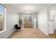 Bright dining room with modern flooring, large window, and views of the backyard at 323 Harpers Ferry Ave, Las Vegas, NV 89148