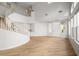 Grand entrance foyer showcasing a curved staircase, high ceilings, and an abundance of natural light at 323 Harpers Ferry Ave, Las Vegas, NV 89148