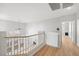 Bright hallway boasts wood floors, a railing overlooking the lower level, and a ceiling fan at 323 Harpers Ferry Ave, Las Vegas, NV 89148