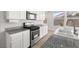 Bright kitchen with granite countertops, stainless steel appliances, and white cabinets at 323 Harpers Ferry Ave, Las Vegas, NV 89148