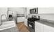 Modern kitchen featuring granite countertops and stainless steel appliances at 323 Harpers Ferry Ave, Las Vegas, NV 89148