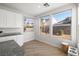 Bright kitchen features granite countertops, white cabinetry, and sunlit windows at 323 Harpers Ferry Ave, Las Vegas, NV 89148