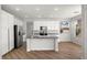 Well-lit kitchen featuring granite countertops, stainless steel appliances, and white cabinets at 323 Harpers Ferry Ave, Las Vegas, NV 89148
