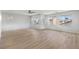 Spacious living room boasting natural light, modern wood flooring, and multiple windows at 323 Harpers Ferry Ave, Las Vegas, NV 89148