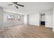Bright living room featuring hardwood floors, multiple windows and a ceiling fan at 323 Harpers Ferry Ave, Las Vegas, NV 89148