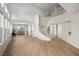 Spacious living room featuring high ceilings, large windows, and a curved staircase at 323 Harpers Ferry Ave, Las Vegas, NV 89148