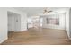 Open-concept living room with modern flooring seamlessly connecting to the kitchen and backyard access at 323 Harpers Ferry Ave, Las Vegas, NV 89148