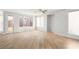 Bright, airy living room with wood-look floors, ceiling fan, and natural light at 323 Harpers Ferry Ave, Las Vegas, NV 89148