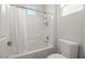 Clean bathroom featuring a shower/tub combination with a white shower curtain and tiled walls at 323 Harpers Ferry Ave, Las Vegas, NV 89148