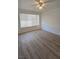 This bedroom features modern flooring, a large window for natural light, and a ceiling fan at 3425 E Russell Rd # 265, Las Vegas, NV 89120