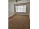 Bedroom with neutral carpet, ceiling fan, and window letting in light at 3425 E Russell Rd # 265, Las Vegas, NV 89120