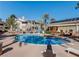 Inviting community pool with lounge chairs and well-maintained landscaping under a clear blue sky at 3425 E Russell Rd # 265, Las Vegas, NV 89120