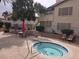 Inviting community pool area with jacuzzi, tables, and chairs for relaxing by the pool at 3425 E Russell Rd # 265, Las Vegas, NV 89120